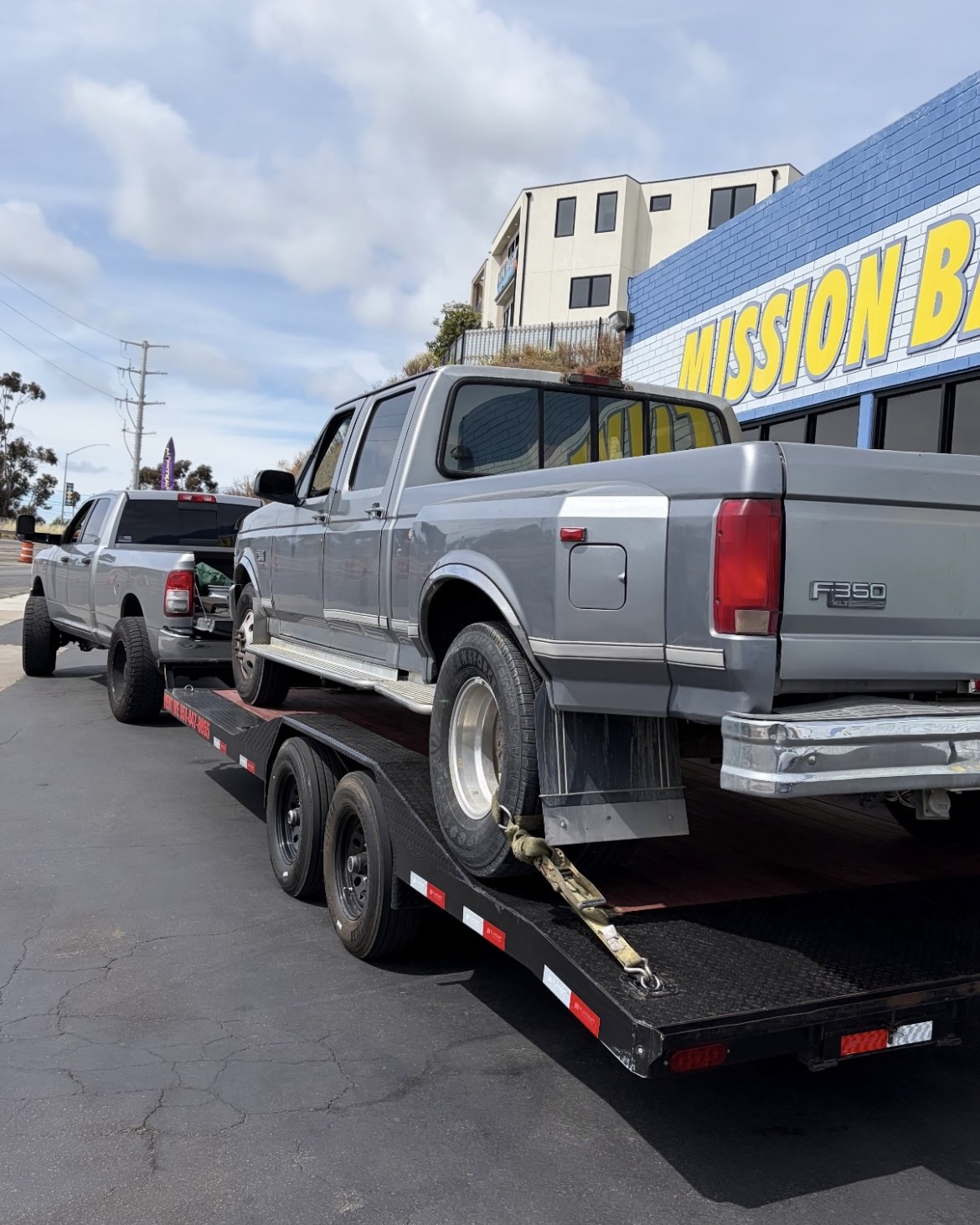 Car hauler trailer carrying a classic Ford F350 in Southern California